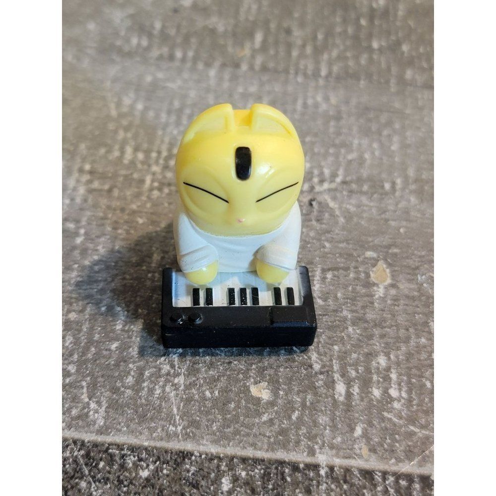 Mini yellow tabby cat playing piano toy figure